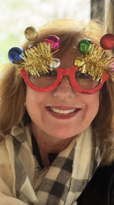 Sandy celebrating in playful holiday glasses